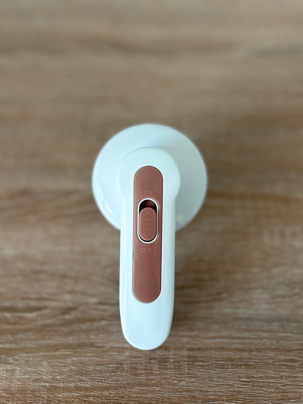 CocoonRevive Electric Lint Remover - back view showing rose gold ON/OFF switch